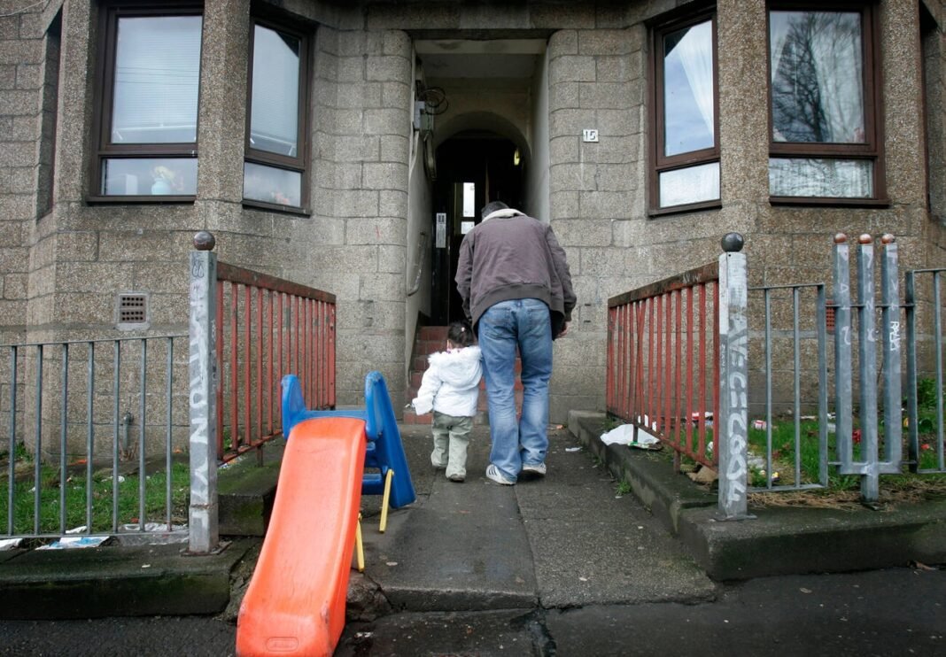 A child and her father on a poverty stricken estate in Maryhill, Glasgow. Tackling child poverty in Scotland